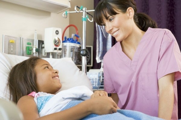 Healthcare worker speaking with a young patient.