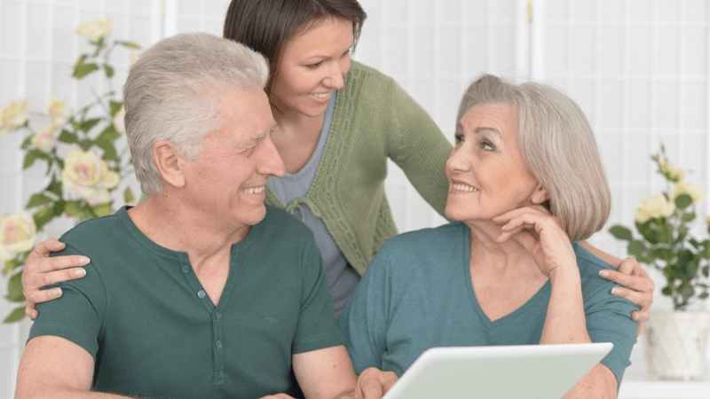 Older couple looking at a computer screen together.