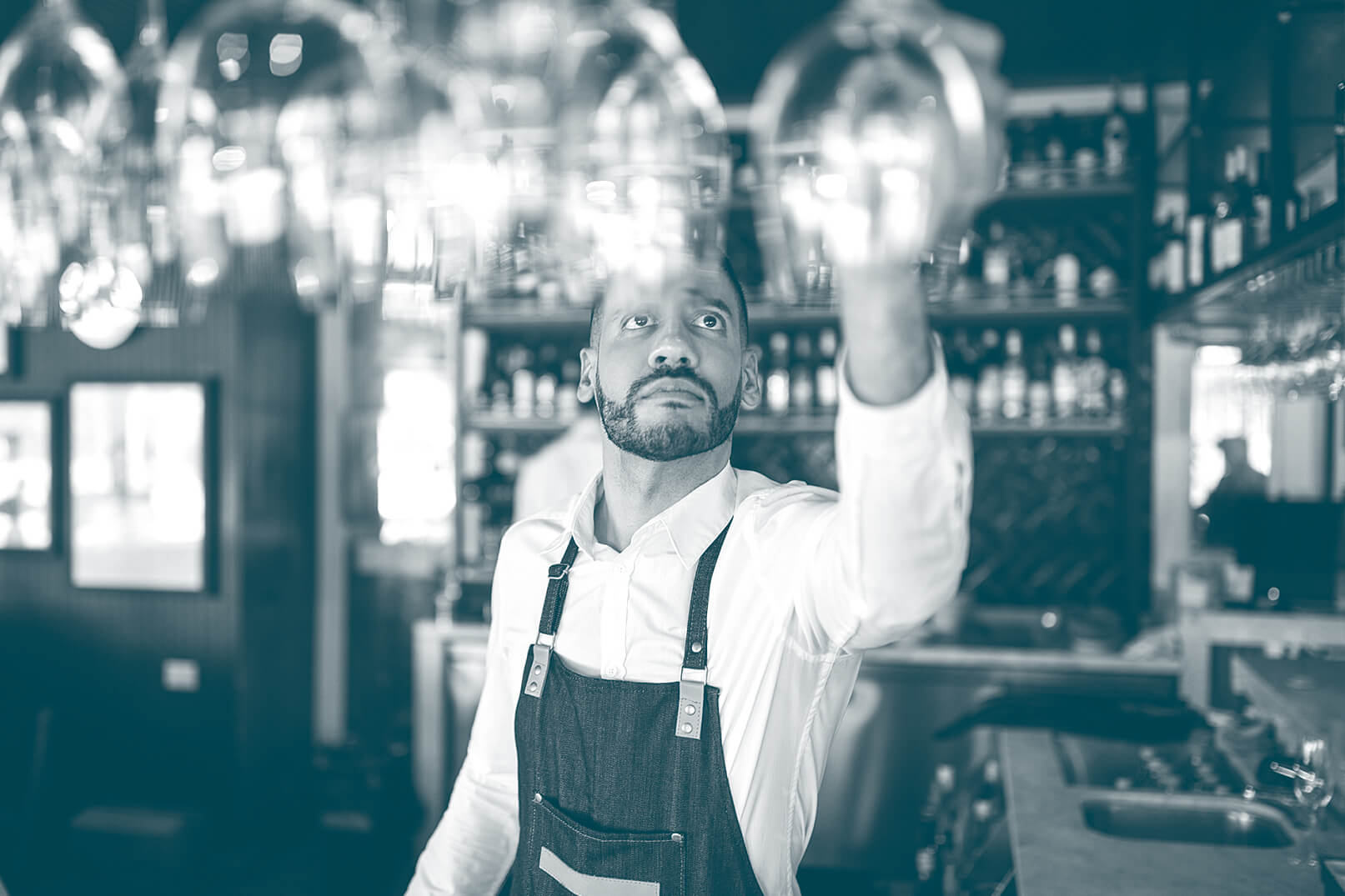 Bartender hanging up a glass