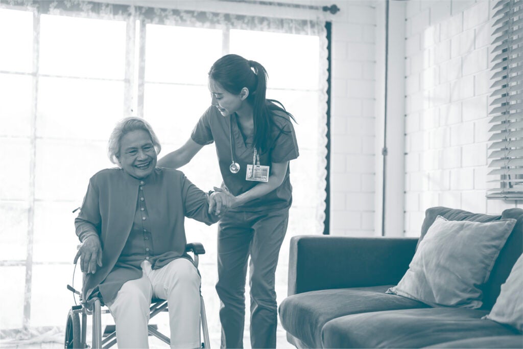 Assisted living nurse helping a resident