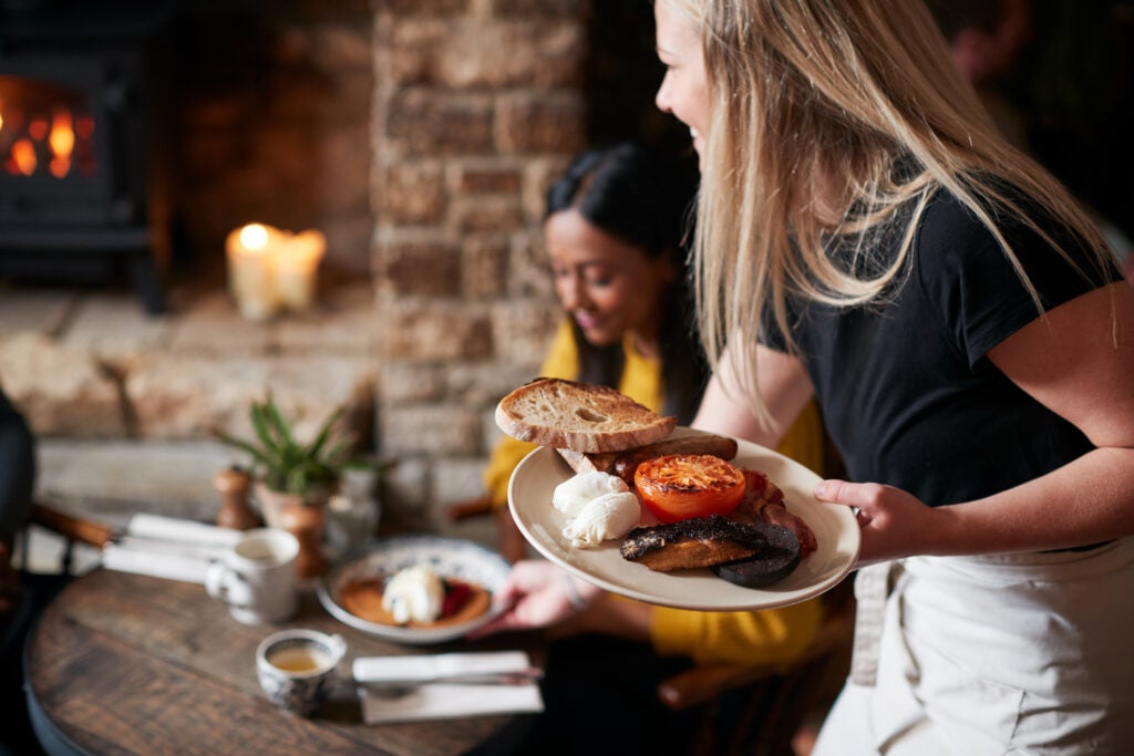 Woman serving food at restaurant