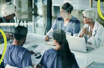 Conference room of five doctors and hospital administrators