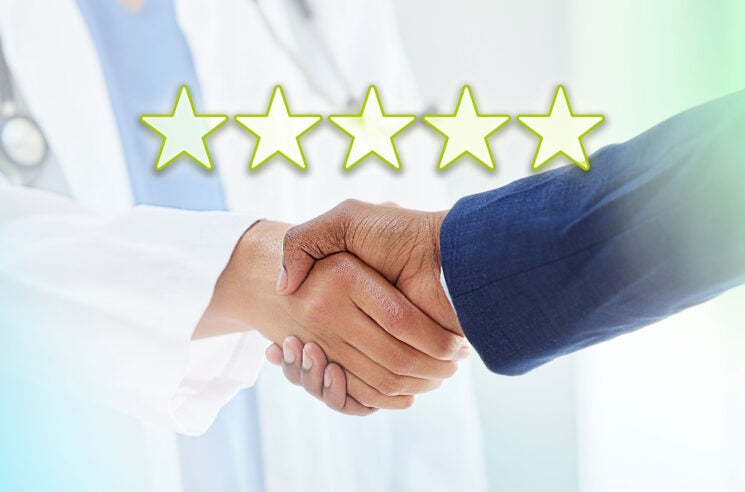 Doctor and businessman shaking hands, rating stars over image.