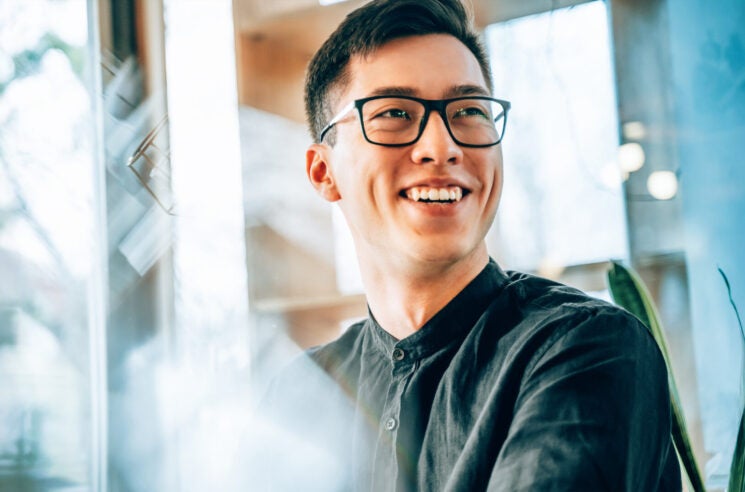 Man sitting at desk, smiling