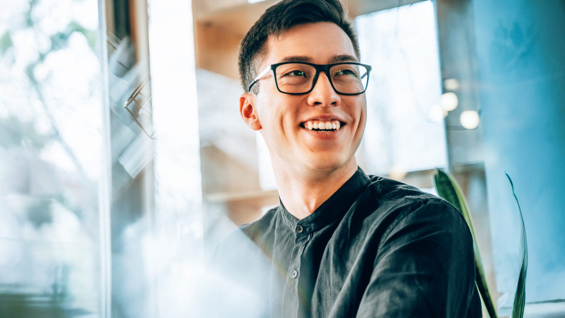 Man sitting at desk, smiling