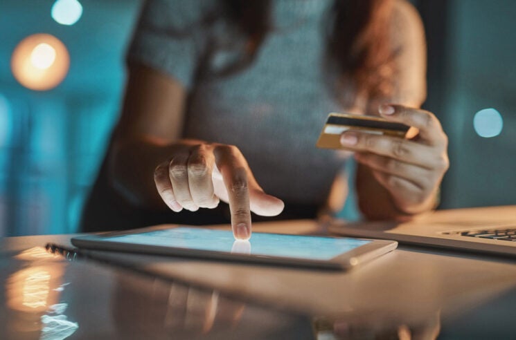 Woman making online purchase on tablet.