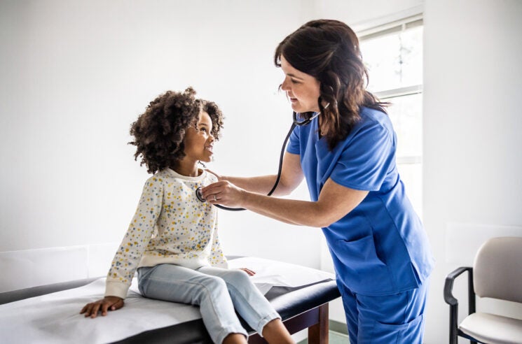 Nurse examining child patient