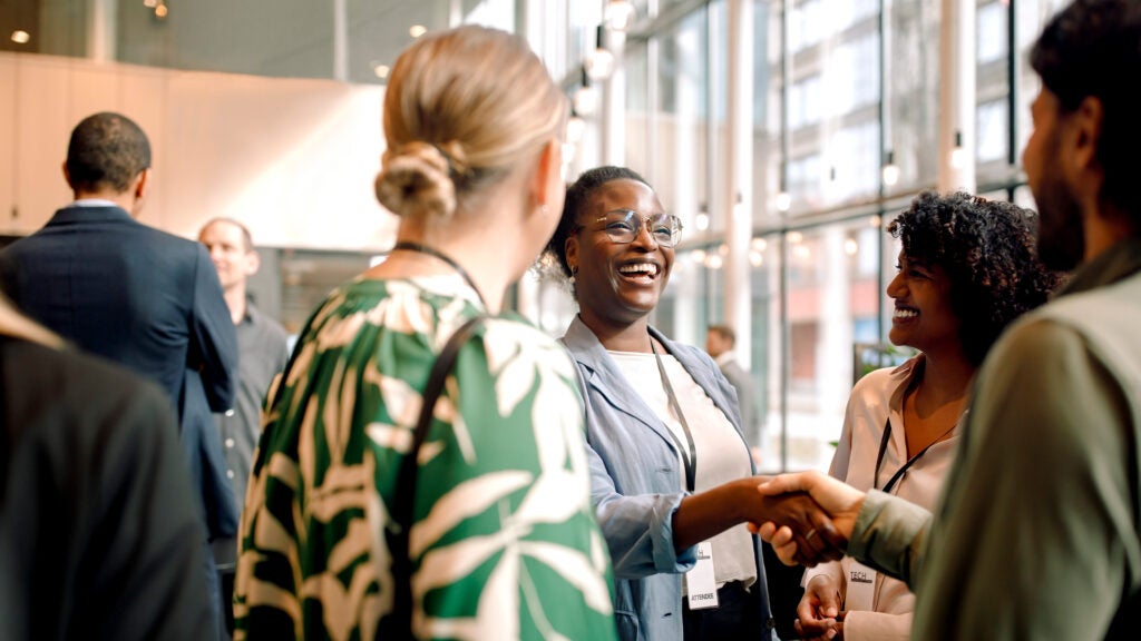 Woman and man shaking hands at a conference
