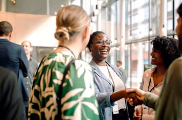 Woman and man shaking hands at a conference
