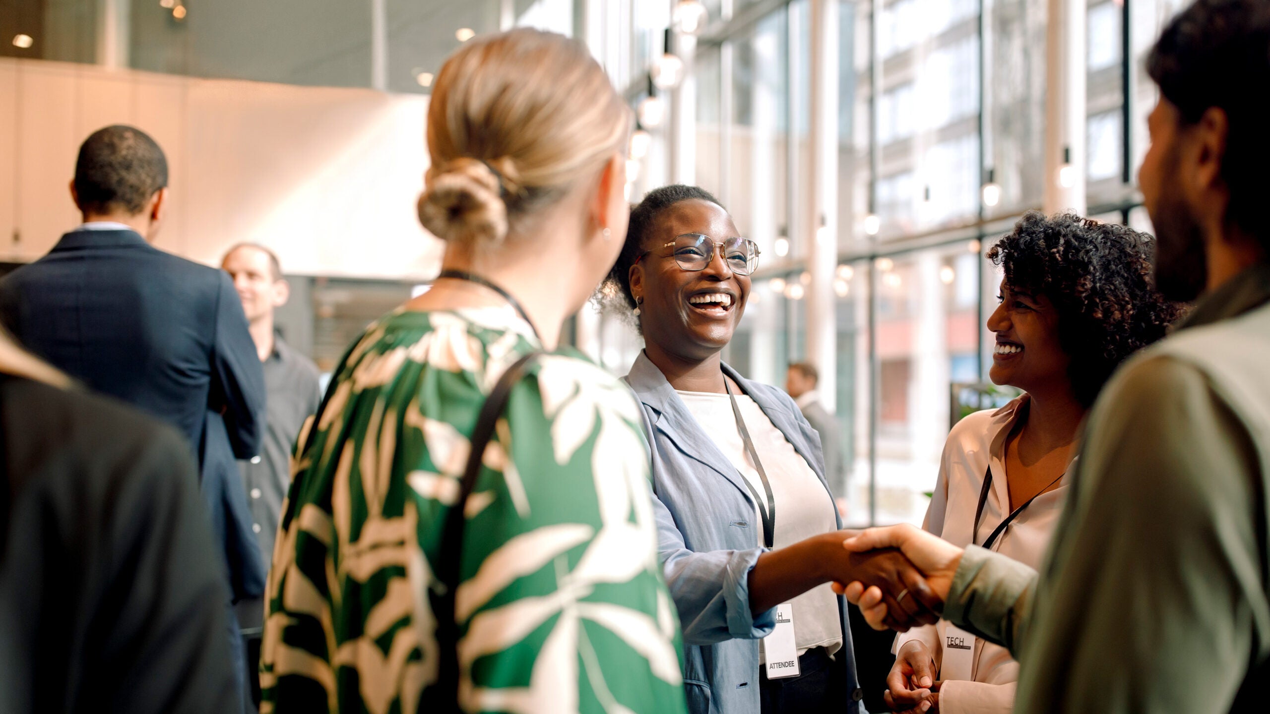 Woman and man shaking hands at a conference