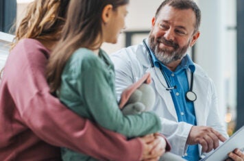 Doctor speaking with a mother and her child