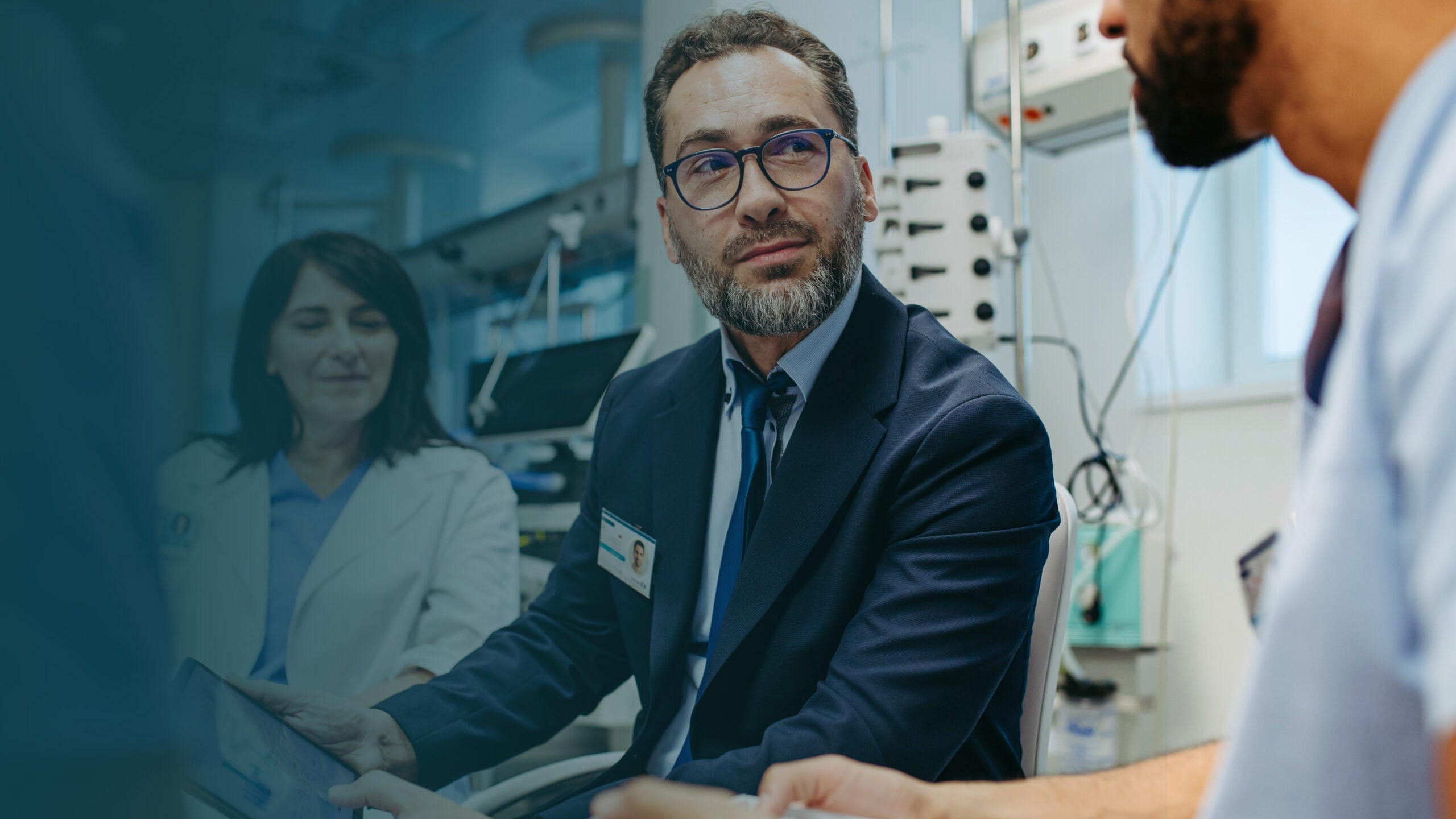 Doctors consulting a patient in a hospital room